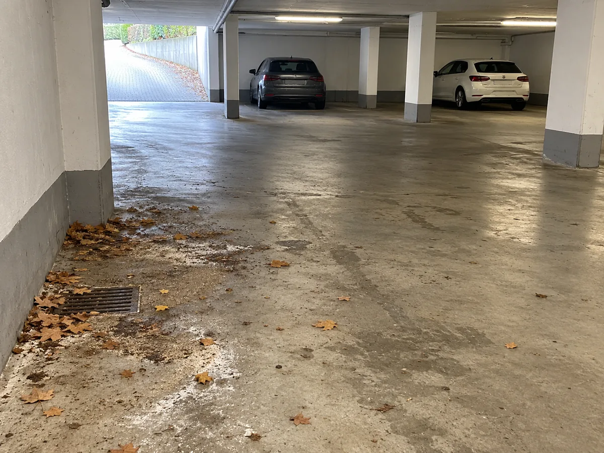 KI-Beispielbild: Laub und Streureste auf dem Boden einer Tiefgarage